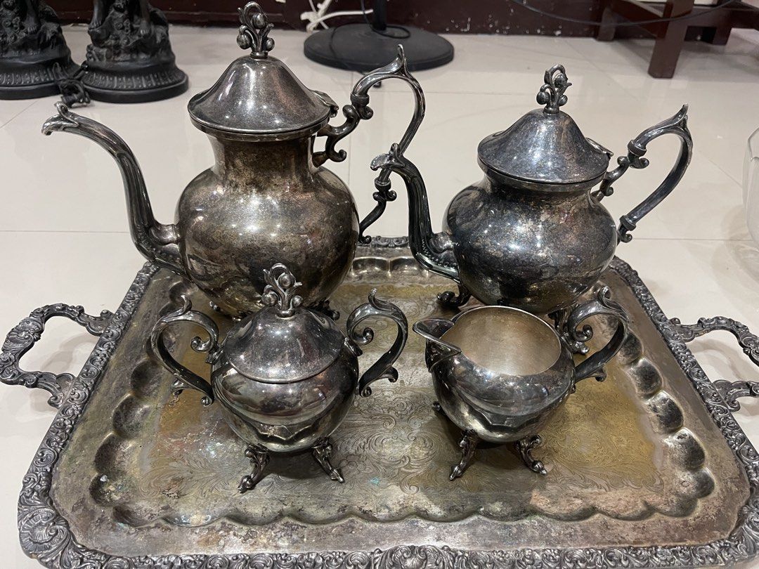 Vintage silver plated tea set with matching tray (Category: Coffee & Tea Tableware) located in Cainta. Submitted by mysticmountain.f41a31 (Listing ID 1469060818, Image 2). Description: Matching silver plated tea service set on an ornate serving tray. Includes a large coffee pot, medium teapot, sugar bowl with lid, and creamer jug. Ornate handles and footed bases on each piece. Visible tarnish and patina from age and storage. Needs a good polish t