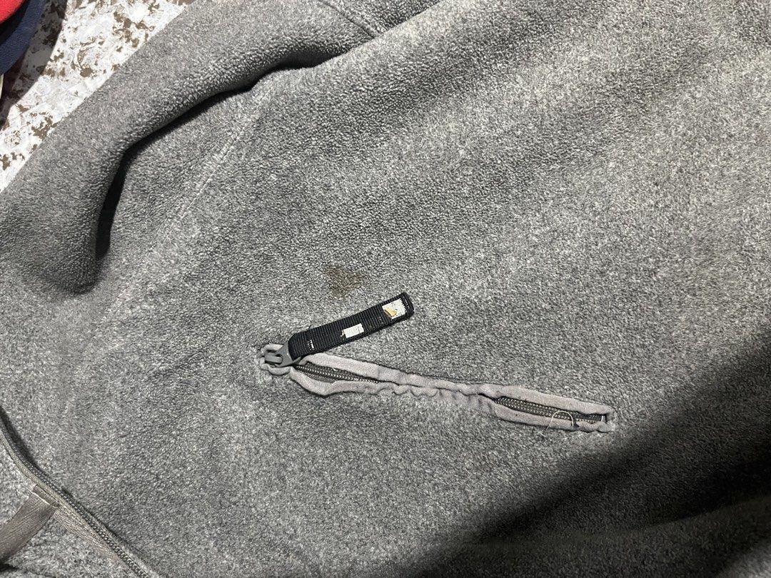 vintageNike Gray Fleece Quarter Zip Pullover (Category: Coats, Jackets and Outerwear) located in Maasin. Submitted by niconii090 (Listing ID 1468985954, Image 3). Description: - Brand: Nike - Style: Fleece pullover with quarter-zip collar - 📏 21 x 27.5 (inches) - Material: 100% polyester (Made in Indonesia) - Features: Embroidered Nike logo on left sleeve, small diagonal zippered chest pocket - Condition: Good overall, with a small stain just ab