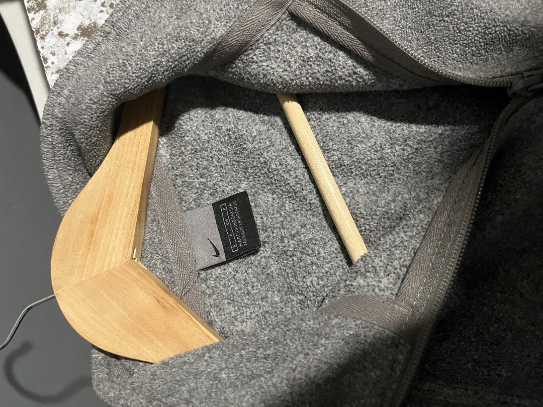 vintageNike Gray Fleece Quarter Zip Pullover (Category: Coats, Jackets and Outerwear) located in Maasin. Submitted by niconii090 (Listing ID 1468985954, Image 2). Description: - Brand: Nike - Style: Fleece pullover with quarter-zip collar - 📏 21 x 27.5 (inches) - Material: 100% polyester (Made in Indonesia) - Features: Embroidered Nike logo on left sleeve, small diagonal zippered chest pocket - Condition: Good overall, with a small stain just ab