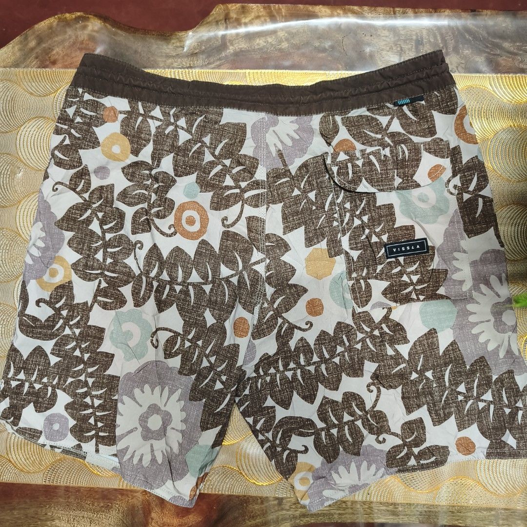 Vissla Floral Board Short (Category: Swim Trunks & Board Shorts) located in Antipolo. Submitted by alphaomega_fox (Listing ID 1469022943, Image 2). Description: - Brand: Vissla - size 32-34x17 - Design: Brown leaf and floral print with dark brown drawstring waist - Material: Upcycled coconut fabric with 4-way stretch for maximum mobility - Features: Quick-dry PFC-free DWR coating, back pocket with velcro flap, and side logo patch - Eco-friendly: 
