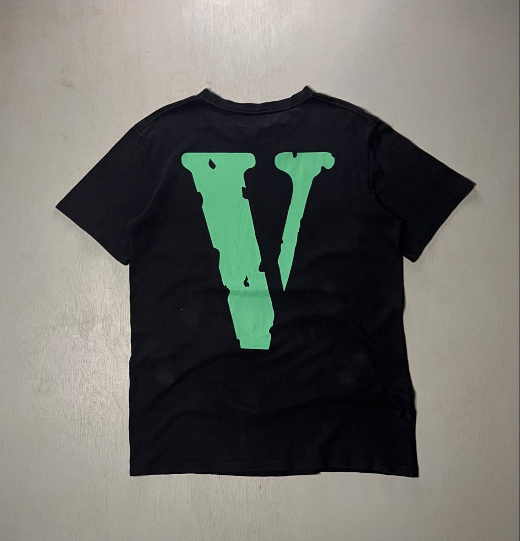 Vlone Green and White Logo (Category: Tshirts & Polo Shirts ) located in Catbalogan. Submitted by yellfindss (Listing ID 1469132513, Image 2). Description: - Color: Black with green and white graphics -21/28 - Design: Large vertical Vlone front print and signature big green V logo on the back - Details: Unique black fabric ribbon attached near the front collar - Material: Soft, premium cotton for daily comfort - Fit: Standard crew neck, regular f