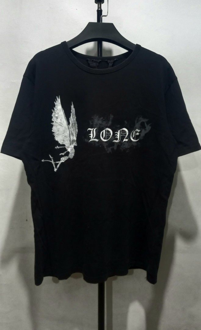 Vlone Lone Black T-Shirt (Category: Tshirts & Polo Shirts ) located in Tarlac. Submitted by den420 (Listing ID 1469108449, Image 1). Description: - Brand: Vlone - Color: Black - Design: "Lone" winged skeleton graphic on front, large V signature logo on back - Fit: Regular fit, short sleeve, classic crew neck - Material: 100% comfortable cotton - Authenticity: Includes signature Vlone interior neck tag - Condition: Brand new / Excellent quality st