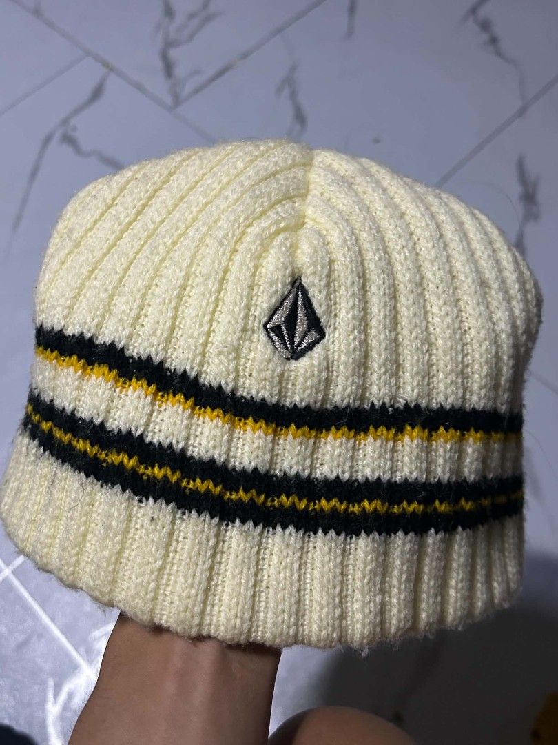 Volcom Ribbed Beanie Hat Cream Yellow Black (Category: Caps & Hats) located in Vigan. Submitted by liahkimole05209 (Listing ID 1469108330, Image 1). Description: - Brand: Volcom - Style: Ribbed beanie in cream with black and yellow stripes - Details: Embroidered stone logo on the front, interior tag attached - Material: Warm knit, great for chilly weather - Condition: Brand new / Excellent.