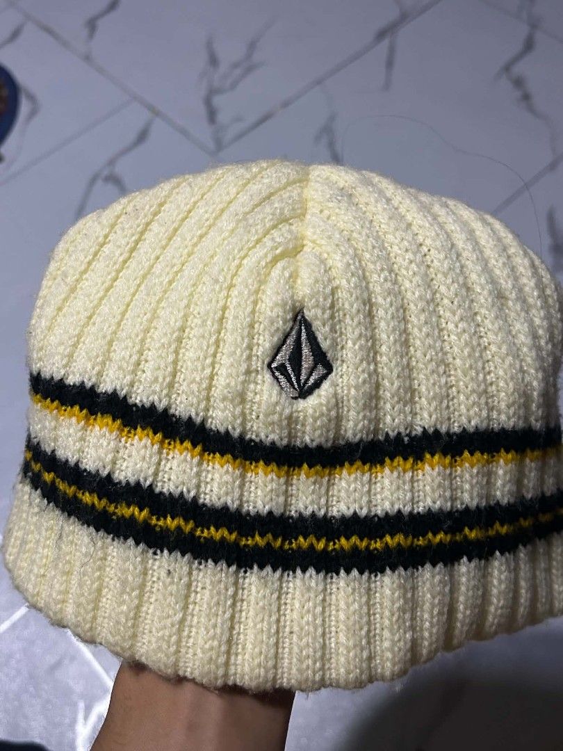 Volcom Ribbed Beanie Hat Cream Yellow Black (Category: Caps & Hats) located in Vigan. Submitted by liahkimole05209 (Listing ID 1469108330, Image 2). Description: - Brand: Volcom - Style: Ribbed beanie in cream with black and yellow stripes - Details: Embroidered stone logo on the front, interior tag attached - Material: Warm knit, great for chilly weather - Condition: Brand new / Excellent.