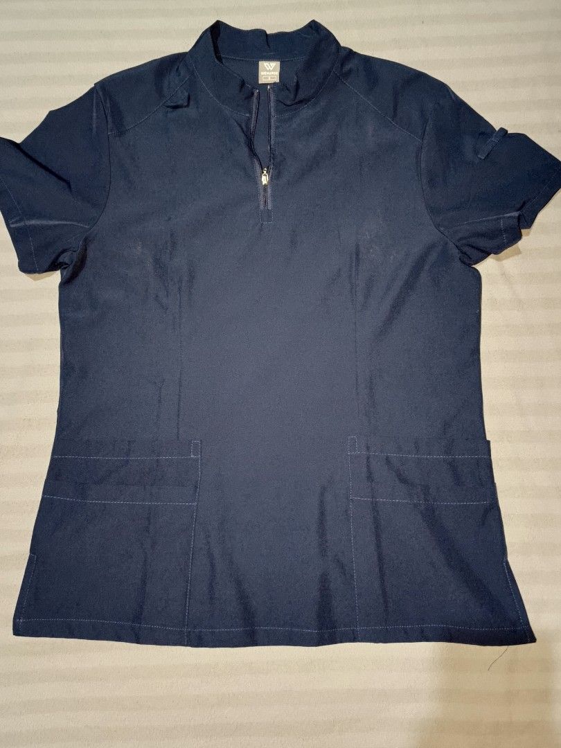 WENURSE Navy Blue Scrubs Set Size S (Category: Sets or Coordinates) located in Taguig. Submitted by yunisya_ (Listing ID 1469033035, Image 1). Description: - Brand: WENURSE - Color: Navy Blue - Size: Small - Top: Half-zip neckline with multiple front pockets - Pants: Elastic drawstring waistband with cargo pockets - Condition: Clean, well-kept, and comfortable - Ideal for: Nurses, medical staff, and healthcare workers.