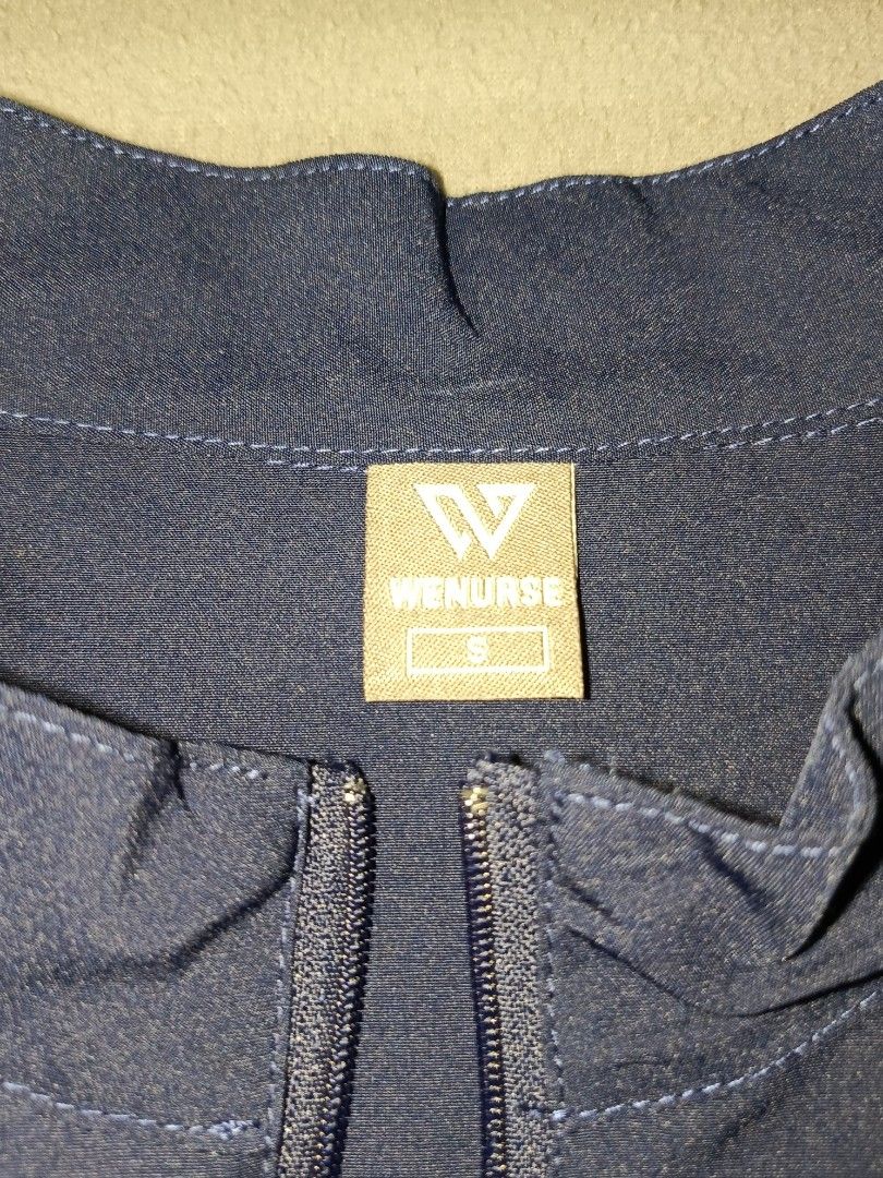 WENURSE Navy Blue Scrubs Set Size S (Category: Sets or Coordinates) located in Taguig. Submitted by yunisya_ (Listing ID 1469033035, Image 2). Description: - Brand: WENURSE - Color: Navy Blue - Size: Small - Top: Half-zip neckline with multiple front pockets - Pants: Elastic drawstring waistband with cargo pockets - Condition: Clean, well-kept, and comfortable - Ideal for: Nurses, medical staff, and healthcare workers.