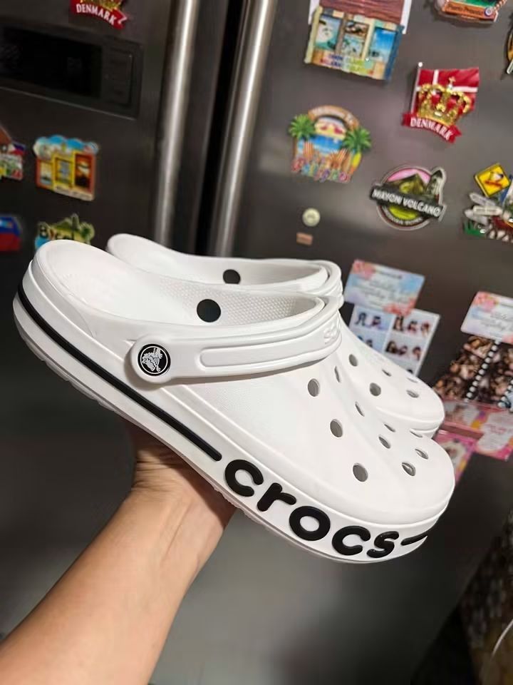 White Crocs Bayaband Clog with Black Logo (Category: Slippers and slides) located in Cebu City. Submitted by madeskartegirl (Listing ID 1468977519, Image 3). Description: 5-11 available - Authentic White Crocs Bayaband clogs - Classic ventilation holes for breathability - Secure pivoting heel straps with Crocs branding - Stylish black midsole accent stripe with bold Crocs logo - Comfortable slip-on design perfect for daily casual wear.