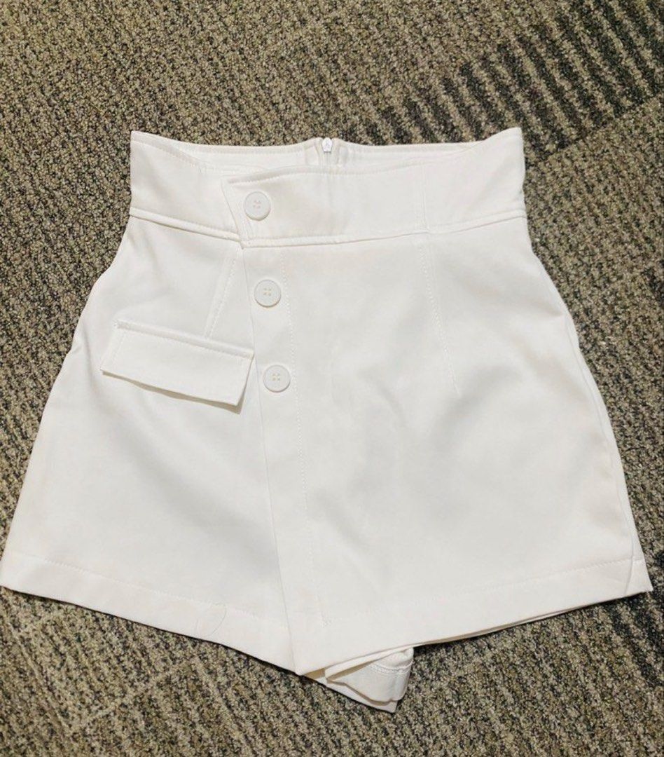 White High-Waisted Skorts with Button Details (Category: Skirts) located in Marikina City. Submitted by jessylady10 (Listing ID 1468981483, Image 1). Description: - Color: White - Style: High-waisted skorts with asymmetric front flap - Comfort: Built-in shorts underneath for worry-free movement - Details: Decorative front buttons and small structured side pocket - Closure: Clean back with hidden top-center zipper - Fabric: Smooth with minimal str