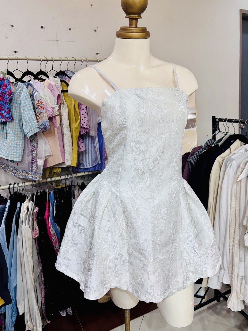 White Jacquard Spaghetti Strap Mini Dress (Category: Dresses) located in Lipa City. Submitted by classyces24 (Listing ID 1469048738, Image 1). Description: - Color: White - Style: Spaghetti strap mini dress with a trendy square neckline - Design: Textured floral jacquard pattern with a fitted bodice and flared bubble skirt - Features: Adjustable thin shoulder straps and lightweight fabric - Best for: Parties, dates, and casual day-outs - Conditio
