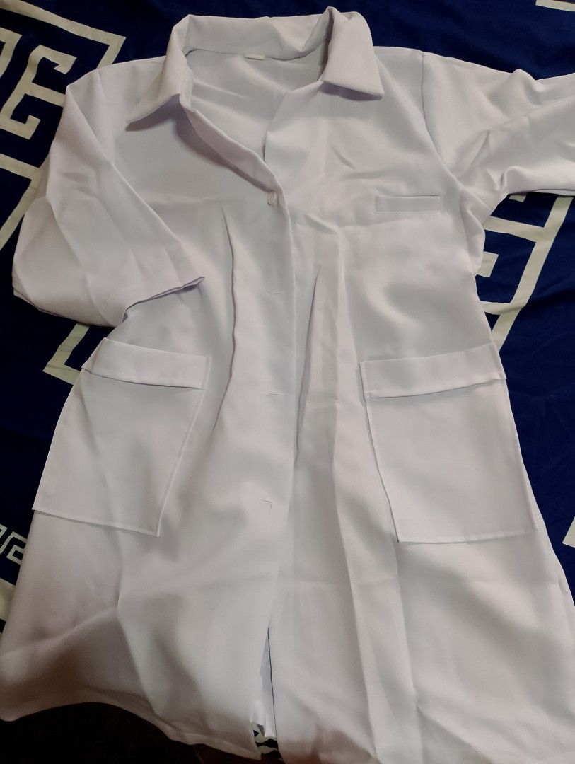 White lab coat with multiple pockets (Category: Coats, Jackets and Outerwear) located in Bulacan. Submitted by lauriee. (Listing ID 1468968999, Image 1). Description: - Color: Plain white - Design: Standard lapel collar with front button closure - Storage: Two large lower patch pockets and one chest pocket - Material: Lightweight, easy-to-wash fabric - Best For: Science labs, medical work, and costume use.