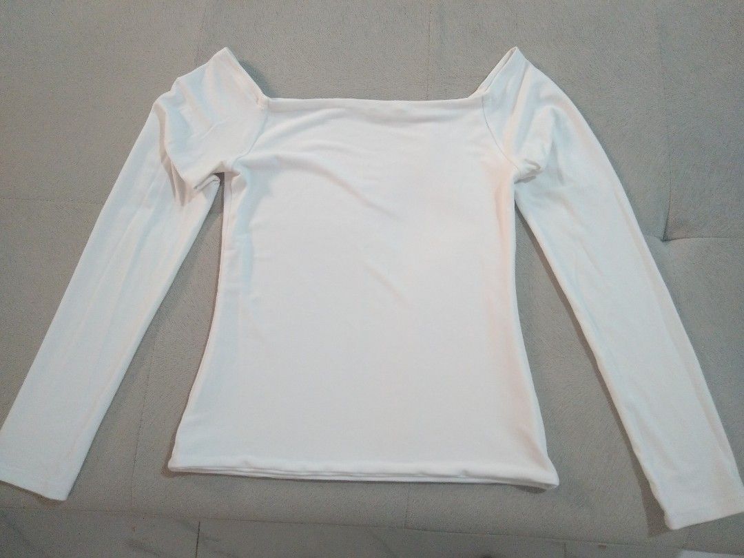 White off-shoulder long sleeve top (Category: Longsleeves) located in Marikina City. Submitted by newowners2025 (Listing ID 1468948811, Image 3). Description: Size: Best fit for Small (Medium on Tag) Bust: 32-35 in Waist: 24-28 in Style: Form-fitting off-shoulder long sleeve (Stay-in-place off shoulder) Fabric: Soft and stretchy for comfort Versatility: Easy to dress up or pair casually with jeans Condition: No issues.