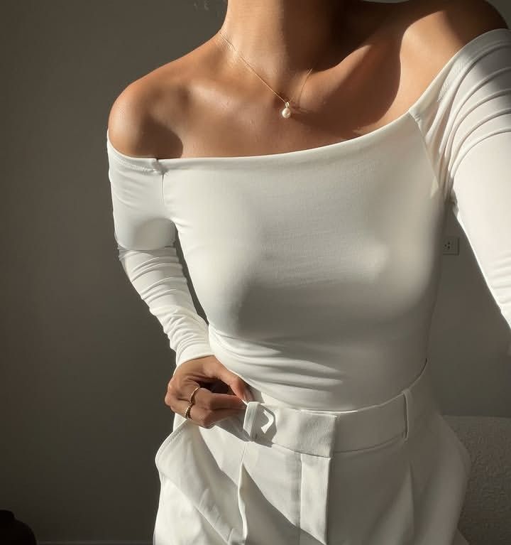 White off-shoulder long sleeve top (Category: Longsleeves) located in Marikina City. Submitted by newowners2025 (Listing ID 1468948811, Image 2). Description: Size: Best fit for Small (Medium on Tag) Bust: 32-35 in Waist: 24-28 in Style: Form-fitting off-shoulder long sleeve (Stay-in-place off shoulder) Fabric: Soft and stretchy for comfort Versatility: Easy to dress up or pair casually with jeans Condition: No issues.