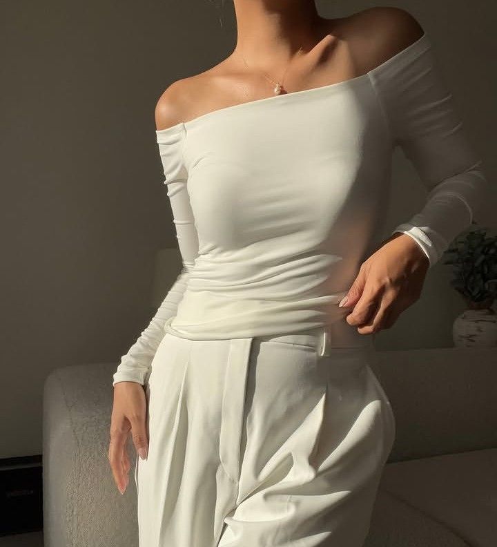 White off-shoulder long sleeve top (Category: Longsleeves) located in Marikina City. Submitted by newowners2025 (Listing ID 1468948811, Image 1). Description: Size: Best fit for Small (Medium on Tag) Bust: 32-35 in Waist: 24-28 in Style: Form-fitting off-shoulder long sleeve (Stay-in-place off shoulder) Fabric: Soft and stretchy for comfort Versatility: Easy to dress up or pair casually with jeans Condition: No issues.