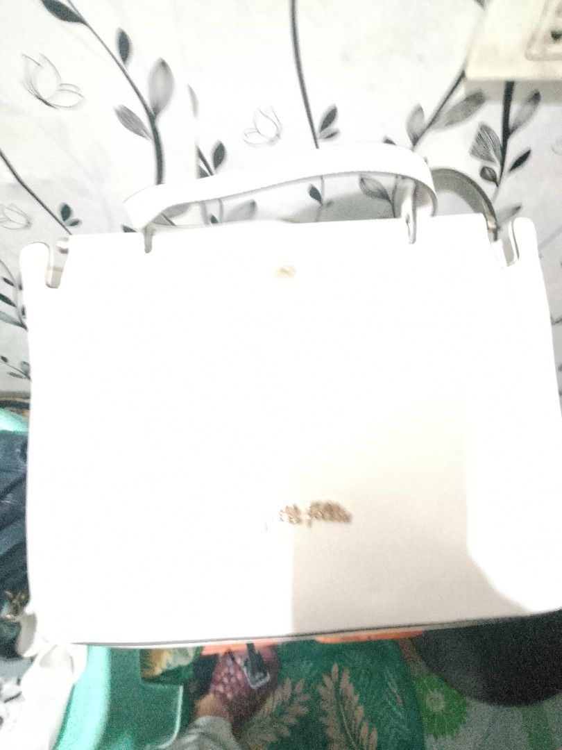 White Tote Bag with Shoulder Straps (Category: Tote Bags) located in Malabon City. Submitted by marierp70 (Listing ID 1468949016, Image 1). Description: - Color: Solid white with chic gold lettering logo near the bottom front - Straps: Dual shoulder straps securely attached with durable metal hardware - Closure: Convenient and secure top magnetic snap button - Design: Clean, minimalist style ideal for daily use, work, or casual outings.