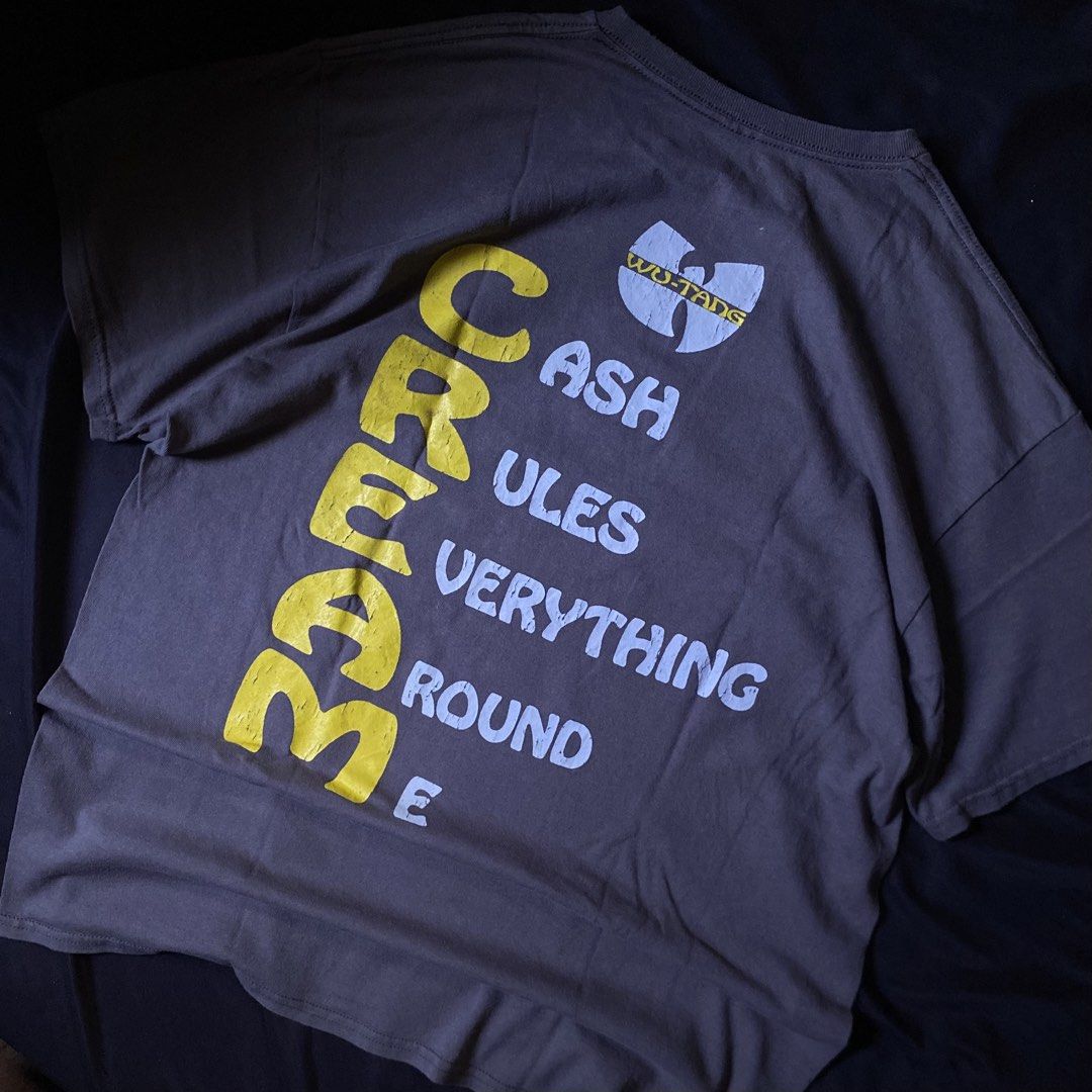Wu-Tang Clan C.R.E.A.M. Graphic Tee (Category: Tshirts & Polo Shirts ) located in Manila. Submitted by wapsshirts (Listing ID 1469064164, Image 2). Description: - Color: Dark grey with distressed yellow and white prints - Design: Large Wu-Tang logo on front, vertical C.R.E.A.M. and "Cash Rules Everything Around Me" text on the back - Details: Small Wu-Tang logo near the back collar -22-29 - Fit: Short sleeves, classic crew neck - Style: Vintage, 