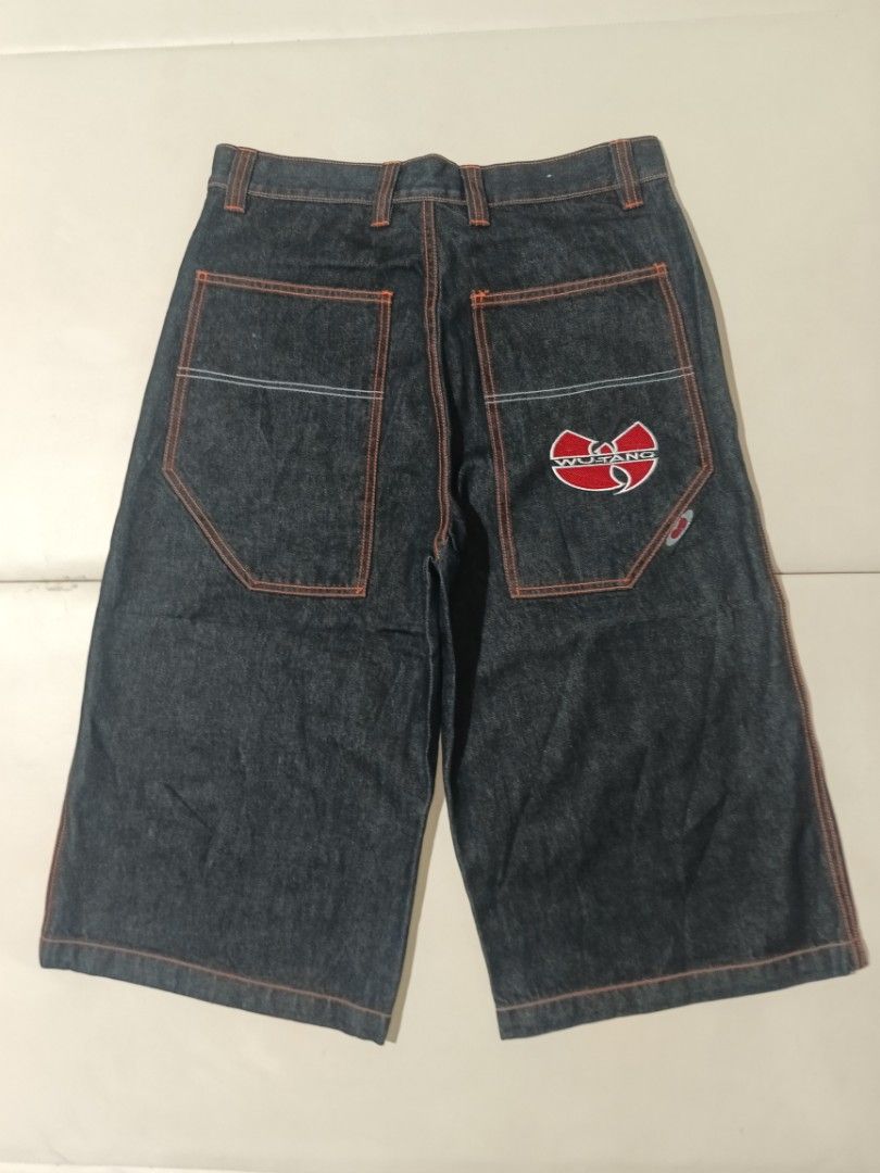Wu-Tang Denim Shorts Size 32 (Category: Shorts) located in Carcar. Submitted by rolandobac92675 (Listing ID 1468974070, Image 3). Description: - Brand: Wu-Tang - Item: Denim Shorts - Wash: Dark Wash - Size: 32 - Fit: Relaxed, wide leg style - Details: Large embroidered Wu-Tang logo on back pocket, contrast orange stitching - Condition: Great, clean overall with graphics fully intact - Style: Perfect for streetwear and hip-hop enthusiasts.