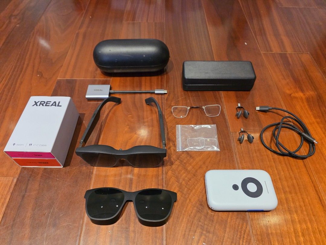 Xreal air 2 pro + Beam (Category: Virtual Reality) located in Pasig City. Submitted by bojsam (Listing ID 1469072092, Image 1). Description: - Complete XREAL Air 2 pro smart glasses bundle for portable AR gaming and media viewing - Includes XREAL Beam device, USB-C cables, and adapter - Comes with prescription lens frame insert and extra nose pads - Includes two protective storage cases - Original packaging box included - Everything shown in phot