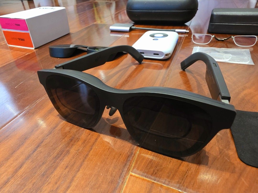 Xreal air 2 pro + Beam (Category: Virtual Reality) located in Pasig City. Submitted by bojsam (Listing ID 1469072092, Image 2). Description: - Complete XREAL Air 2 pro smart glasses bundle for portable AR gaming and media viewing - Includes XREAL Beam device, USB-C cables, and adapter - Comes with prescription lens frame insert and extra nose pads - Includes two protective storage cases - Original packaging box included - Everything shown in phot