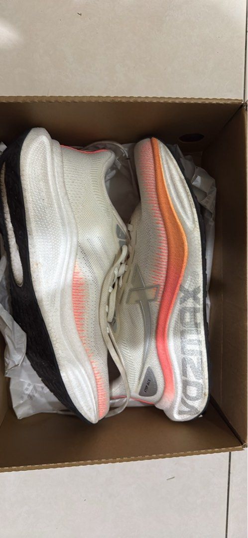 Xtep VO2MAX (Category: Sneakers) located in Kuala Lumpur. Submitted by kimlast0911743 (Listing ID 1468933613, Image 1). Description: - Brand: Xtep - Color: White with orange and pink gradient accents - Upper: Breathable mesh material - Sole: Thick cushioned midsole with black traction outsole - Insoles: Vibrant orange with Xtep branding - Condition / Packaging: Includes original branded cardboard shoe box - Ideal for: Running, workouts, and daily
