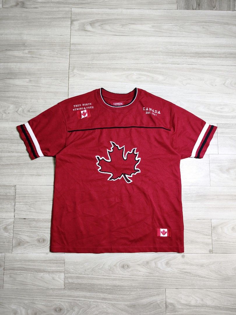 Y2k Canada Athletics Red Maple Leaf Jersey (Category: Activewear) located in Paranaque City. Submitted by pickersform (Listing ID 1469025989, Image 1). Description: - Canada Athletics Jersey - Size: XL dimes 24x31 - Front Design: Large embroidered maple leaf graphic 'True North Strong & Free' text, and 'Canada Est. 1867' - Back Design: Large embroidered 'Canada' lettering across the shoulders - Condition: Excellent no flaws .