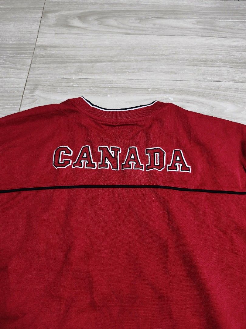Y2k Canada Athletics Red Maple Leaf Jersey (Category: Activewear) located in Paranaque City. Submitted by pickersform (Listing ID 1469025989, Image 3). Description: - Canada Athletics Jersey - Size: XL dimes 24x31 - Front Design: Large embroidered maple leaf graphic 'True North Strong & Free' text, and 'Canada Est. 1867' - Back Design: Large embroidered 'Canada' lettering across the shoulders - Condition: Excellent no flaws .