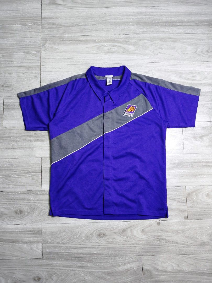 Y2k NBA Phoenix Suns warmer jersey button down polo (Category: Tshirts & Polo Shirts ) located in Paranaque City. Submitted by pickersform (Listing ID 1469021207, Image 1). Description: - Y2k NBA Phoenix Suns warmer jersey button down polo - Size:XLyouth fits Medium-Large dimes 23x29 - Details: Embroidered Suns logo on chest, large embroidered SUNS lettering on the back - Condition: Clean fabric with bright, vibrant colors.