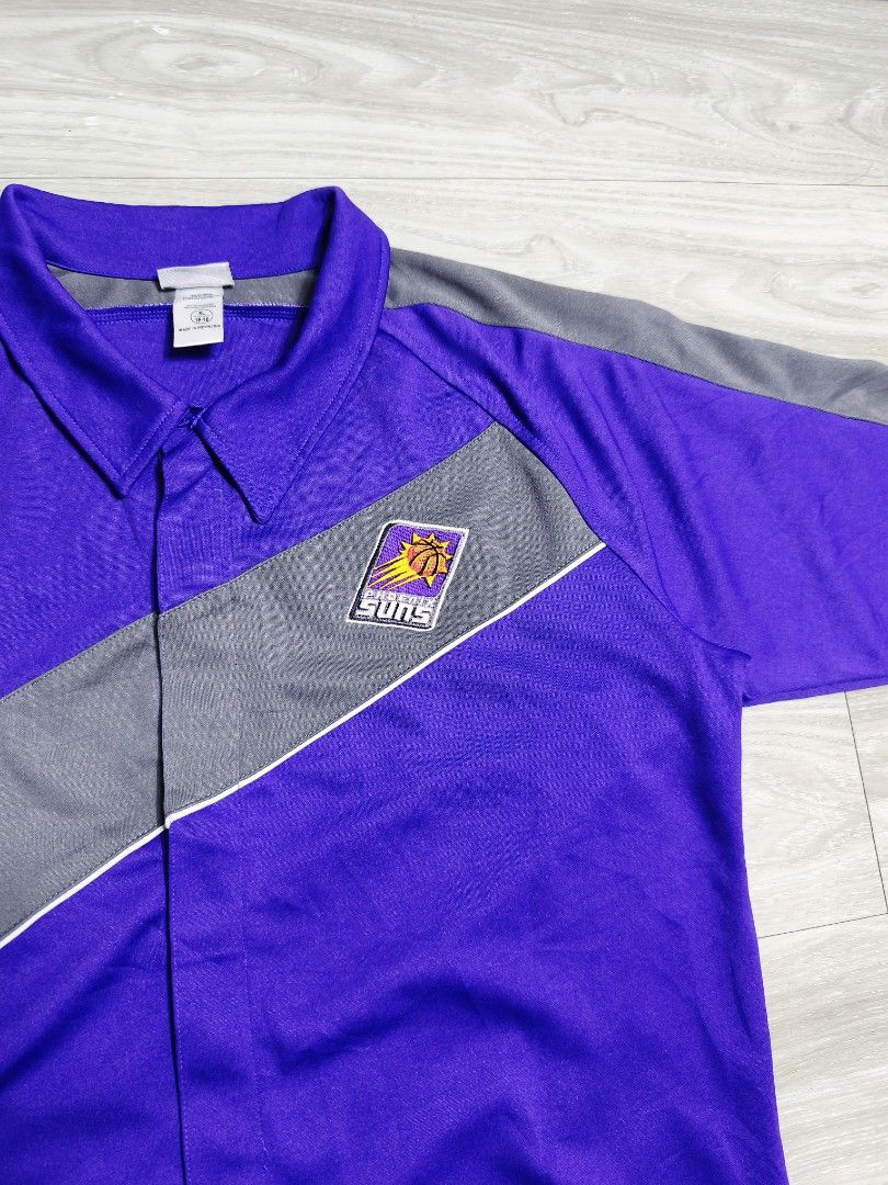 Y2k NBA Phoenix Suns warmer jersey button down polo (Category: Tshirts & Polo Shirts ) located in Paranaque City. Submitted by pickersform (Listing ID 1469021207, Image 3). Description: - Y2k NBA Phoenix Suns warmer jersey button down polo - Size:XLyouth fits Medium-Large dimes 23x29 - Details: Embroidered Suns logo on chest, large embroidered SUNS lettering on the back - Condition: Clean fabric with bright, vibrant colors.