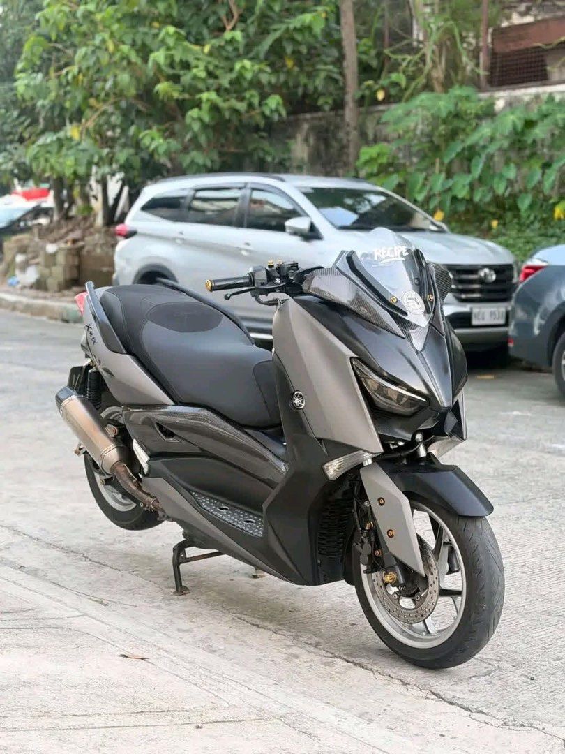 Yamaha XMAX Maxi Scooter Grey (Category: Motorbikes for Sale) located in Quezon City. Submitted by gladysgeron (Listing ID 1469028372, Image 1). Description: Yamaha XMAX maxi scooter in grey and black. Big comfortable seat, sporty windshield with Recipe sticker. Aftermarket exhaust pipe installed. Dual brake setup up front. Twin rear shock absorbers. Center stand equipped. Clean body panels and alloy wheels. Rides smooth on city streets. Great da