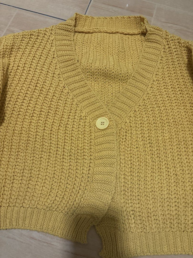 Yellow Knit Cropped Cardigan Sweater (Category: Coats, Jackets and Outerwear) located in Cabuyao City. Submitted by airpz (Listing ID 1469068402, Image 3). Description: - Color: Mustard yellow - Style: Cropped, heavy chunky knit - Features: V-neck with ribbed trim, long sleeves with ribbed cuffs and hem, single large front button - Condition/Vibe: Cozy, warm, and stylish for everyday wear.