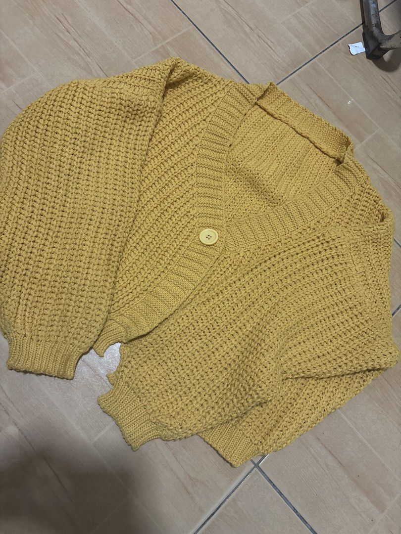 Yellow Knit Cropped Cardigan Sweater (Category: Coats, Jackets and Outerwear) located in Cabuyao City. Submitted by airpz (Listing ID 1469068402, Image 1). Description: - Color: Mustard yellow - Style: Cropped, heavy chunky knit - Features: V-neck with ribbed trim, long sleeves with ribbed cuffs and hem, single large front button - Condition/Vibe: Cozy, warm, and stylish for everyday wear.