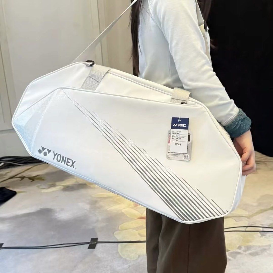 Yonex White Badminton Tournament Bag (Category: Racket and Ball Sports) located in Taguig. Submitted by mengxir20193848 (Listing ID 1469089805, Image 2). Description: - Brand: Yonex - Condition: Brand new with original tags attached - Color: White with grey stripe details and bold logo branding - Hardware: Durable YKK zippers with reinforced pull tabs - Strap: Long adjustable shoulder strap for comfortable carrying - Storage: Spacious main compar