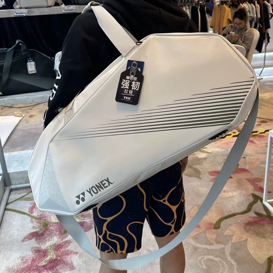 Yonex White Badminton Tournament Bag (Category: Racket and Ball Sports) located in Taguig. Submitted by mengxir20193848 (Listing ID 1469089805, Image 1). Description: - Brand: Yonex - Condition: Brand new with original tags attached - Color: White with grey stripe details and bold logo branding - Hardware: Durable YKK zippers with reinforced pull tabs - Strap: Long adjustable shoulder strap for comfortable carrying - Storage: Spacious main compar