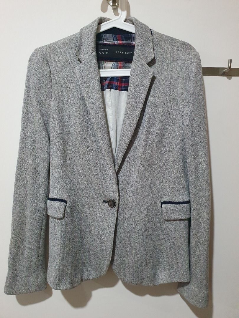 Zara Basic Grey Blazer Jacket (Category: Coats, Jackets and Outerwear) located in Petaling Jaya. Submitted by wisedog_223377 (Listing ID 1469048111, Image 1). Description: - Brand/Model: Zara Basic - Size: EUR M (Made in Morocco) - Material: Grey tweed-textured fabric - Design: Single-button closure, front flap pockets with dark blue trim - Lining: Red and blue plaid upper lining, solid white lower lining - Style: Smart casual, easy to dress up o