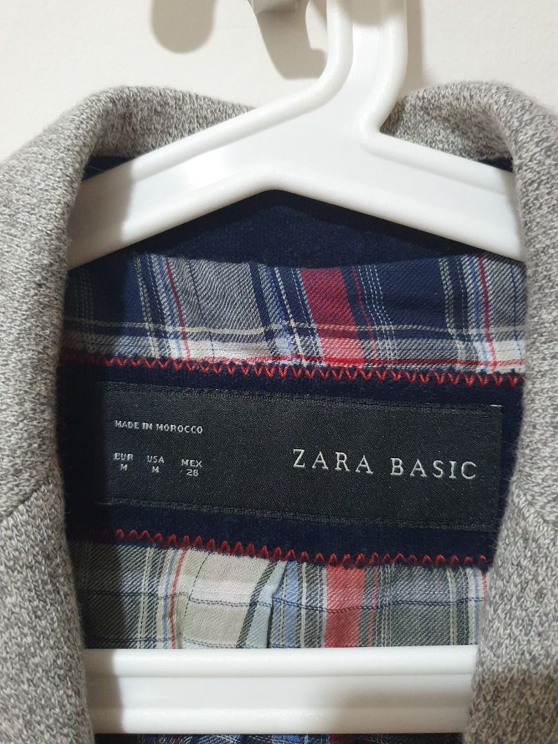 Zara Basic Grey Blazer Jacket (Category: Coats, Jackets and Outerwear) located in Petaling Jaya. Submitted by wisedog_223377 (Listing ID 1469048111, Image 2). Description: - Brand/Model: Zara Basic - Size: EUR M (Made in Morocco) - Material: Grey tweed-textured fabric - Design: Single-button closure, front flap pockets with dark blue trim - Lining: Red and blue plaid upper lining, solid white lower lining - Style: Smart casual, easy to dress up o
