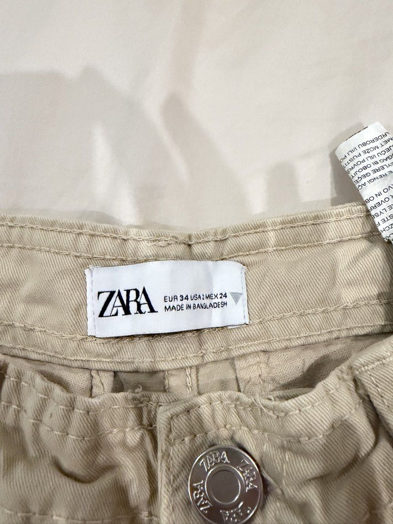 Zara beige cargo pants size EUR 34 (Category: Jeans) located in Manila. Submitted by pinkyclothes1267 (Listing ID 1469029327, Image 3). Description: - Brand: Zara - Style: Cargo pants with multiple front and back utility pockets - Color: Classic beige - Size: EUR 34 / USA 2 / MEX 24 - Material: 100% Cotton (Made in Bangladesh) - Closure: Button closure with zip fly and standard belt loops - Condition: Excellent, ready to wear.