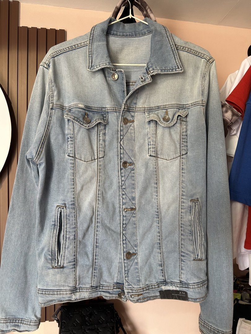 Zara Denim Jacket Light Blue Jean Jacket (Category: Coats, Jackets and Outerwear) located in Vinzons. Submitted by melodylarg85741 (Listing ID 1468983992, Image 1). Description: - Brand/Model: ZM Zara Man Denim Wear - Color: Light wash blue - Design: Classic button-up front with durable metal buttons and a structured collar - Pockets: Two functional chest pockets and two vertical side pockets - Details: Trendy distressed details near the hem with