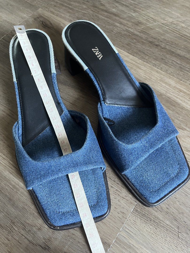 Zara Denim Sandals Size 37 (Category: Flats & Sandals) located in Antipolo. Submitted by rrraves (Listing ID 1468994868, Image 3). Description: - Brand: Zara - Style: Denim mules with square toes and chunky block heels - Size: EU 37 - Material: Blue denim fabric upper, dark insoles, and wooden-look heel - Origin: Made in Spain Hardly used. No issues. MOP: BPI or GCash only. Slightly negotiable. Buyer pays for shipping. Sale is final. .