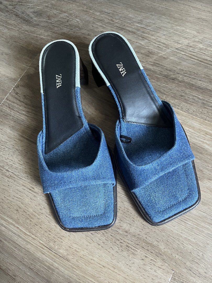 Zara Denim Sandals Size 37 (Category: Flats & Sandals) located in Antipolo. Submitted by rrraves (Listing ID 1468994868, Image 1). Description: - Brand: Zara - Style: Denim mules with square toes and chunky block heels - Size: EU 37 - Material: Blue denim fabric upper, dark insoles, and wooden-look heel - Origin: Made in Spain Hardly used. No issues. MOP: BPI or GCash only. Slightly negotiable. Buyer pays for shipping. Sale is final. .