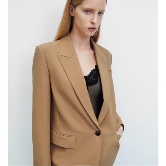 ZARA Oversized Camel Blazer (Category: Coats, Jackets and Outerwear) located in Malolos. Submitted by eadiana (Listing ID 1468969228, Image 2). Description: - Brand: Zara - Size: S - Origin: Made in Spain -Color: Light Caramel - Design: Classic lapel collar, single button closure, and structured shoulders - Details: Front flap pockets, black inner lining, four buttons on each cuff, and single back vent - Condition: Clean finish, ready to wear.