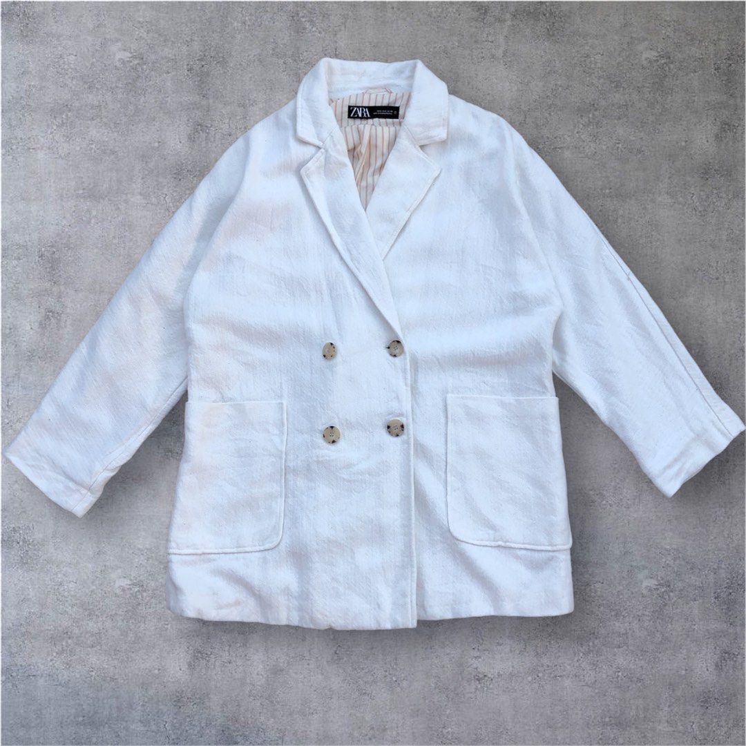 Zara White Double-Breasted Blazer Size S (Category: Coats, Jackets and Outerwear) located in Paranaque City. Submitted by lesstash001 (Listing ID 1469086616, Image 1). Description: - Brand: Zara - Style: Double-breasted blazer - Size: S - Color: White with cream and brown striped inner lining - Details: Tortoiseshell front buttons, structured collar and lapels, two front pockets - Origin: Made in Myanmar - Condition: Excellent / Great for workwea