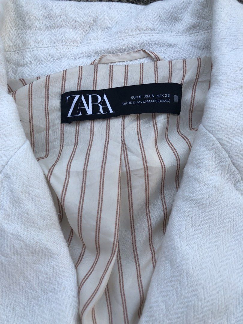Zara White Double-Breasted Blazer Size S (Category: Coats, Jackets and Outerwear) located in Paranaque City. Submitted by lesstash001 (Listing ID 1469086616, Image 2). Description: - Brand: Zara - Style: Double-breasted blazer - Size: S - Color: White with cream and brown striped inner lining - Details: Tortoiseshell front buttons, structured collar and lapels, two front pockets - Origin: Made in Myanmar - Condition: Excellent / Great for workwea