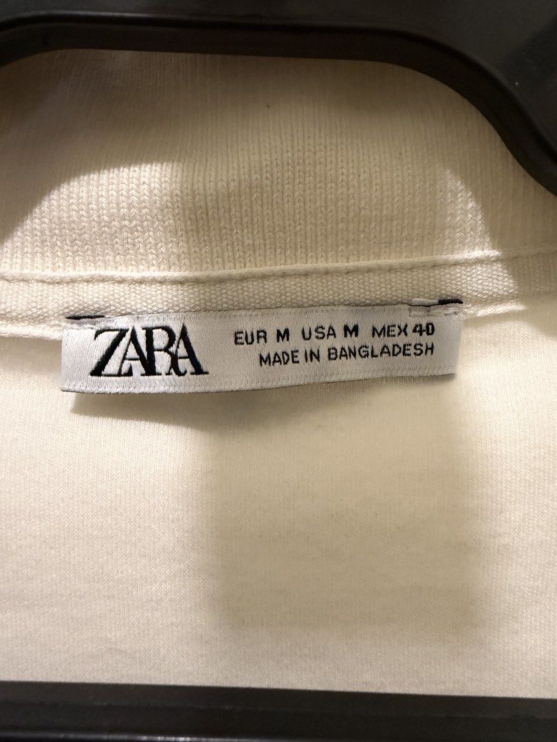 ZARA White Polo Shirt (Category: Tshirts & Polo Shirts ) located in Mandaluyong City. Submitted by icheeellee (Listing ID 1469086238, Image 3). Description: - Brand: ZARA - Size: M - Color: White - Material: Comfortable cotton - Fit: Relaxed fit - Features: Collar neck, short sleeves.