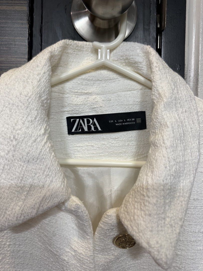 Zara White Textured Tweed Jacket (Category: Coats, Jackets and Outerwear) located in Manila. Submitted by marylemana (Listing ID 1469101014, Image 3). Description: Guaranteed authentic!! - Brand: Zara - Style: White tweed jacket with classic collar - Size: L (Made in Morocco) - Details: Textured fabric, gold-tone embossed metallic buttons, two front patch pockets - Lining: Fully lined interior - Condition: Never been used - Versatility: Perfect l