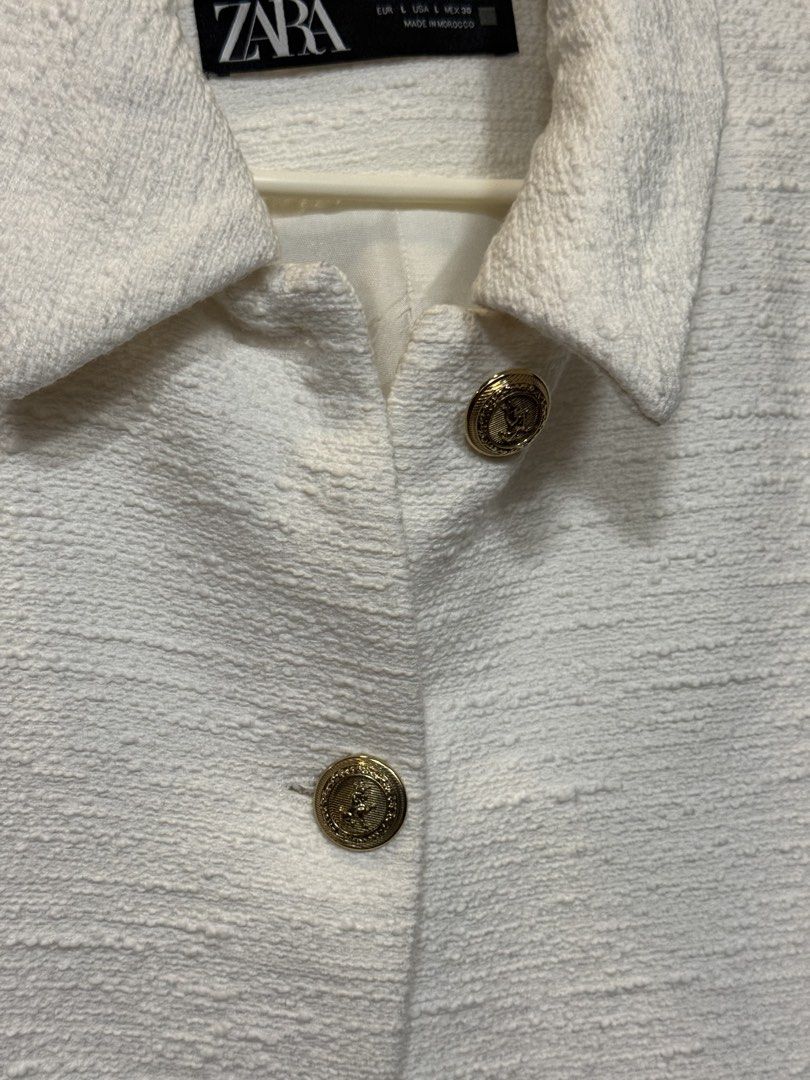 Zara White Textured Tweed Jacket (Category: Coats, Jackets and Outerwear) located in Manila. Submitted by marylemana (Listing ID 1469101014, Image 2). Description: Guaranteed authentic!! - Brand: Zara - Style: White tweed jacket with classic collar - Size: L (Made in Morocco) - Details: Textured fabric, gold-tone embossed metallic buttons, two front patch pockets - Lining: Fully lined interior - Condition: Never been used - Versatility: Perfect l