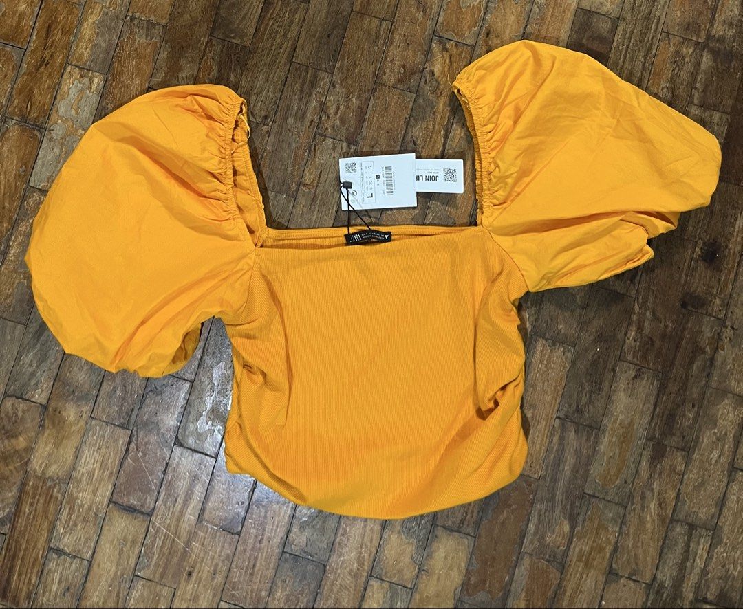 Zara BNWT Puff Sleeve Square Neck Crop Top (Category: Blouses) located in Mandaluyong City. Submitted by hopeworldplane (Listing ID 1469033261, Image 2). Description: - Brand: Zara - Condition: Brand new with tags (never worn) - Color: Bright yellow - Details: Square neckline, voluminous puff sleeves - Fit: Form-fitting ribbed knit body - Perfect for: Summer outfits and nights out.