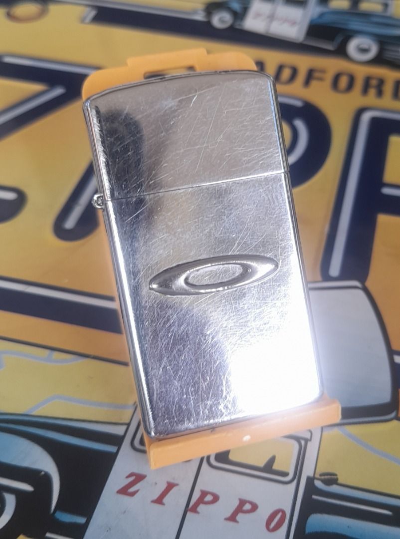 Vintage Zippo Slim Custom Oakley lighter (Category: Vintage Collectibles) located in San Pedro. Submitted by taberna_carpe_diem (Listing ID 1468998325, Image 1). Description: VIntage Zippo Slim in High polished chrome finish w/ custom Oakley ellipse design. W/ case date Jan 1994,insert date Jan 1987. No box, shipping c/o buyer. .