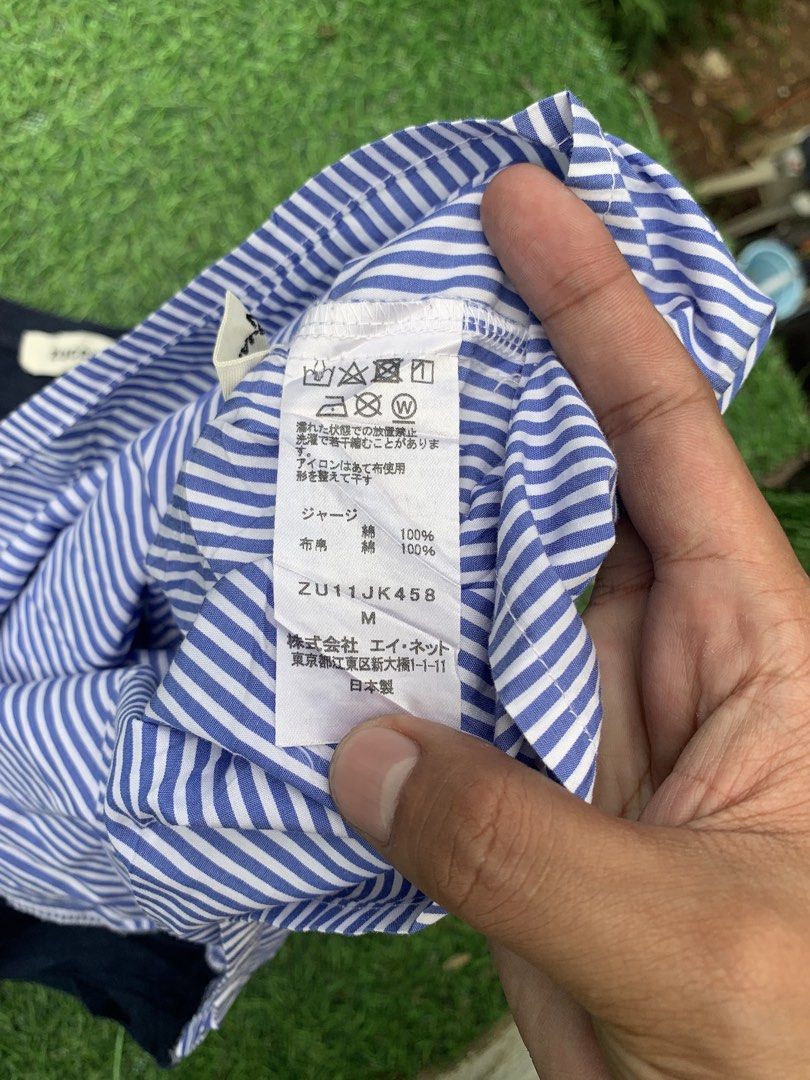 ZUCCA SPLICED ASSYMMETRIC STRIPED SHIRT (Category: Blouses) located in Davao. Submitted by thrift_cuttiiee1000 (Listing ID 1468959017, Image 3). Description: Zucca Modern Spliced Striped T-Shirt Akira Onozuka founded Zucca in 1988 under the Issey Miyake and A-net umbrella, developing a reputation for functional yet whimsical everyday garments. This piece illustrates the brand’s hallmark deconstructionist approach, uniting soft navy cotton jersey 