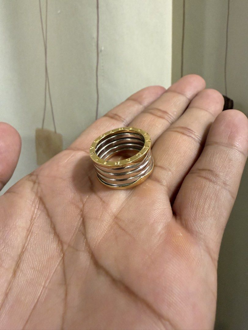 18k Bvlgari B.zero1 4-Band Ring Gold Silver (Category: Rings) located in Binalonan. Submitted by sheenaluxarchive (Listing ID 1465493540, Image 1). Description: - Authentic 18k gold Bvlgari B.zero1 Ring - 4-band architectural spiral design - Stunning two-tone combination of yellow gold and white metal - Iconic engraved BVLGARI lettering on top and bottom edges - Premium luxury statement piece for any occasion.
