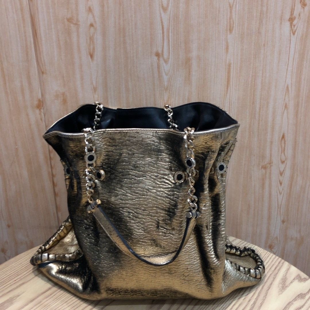 267009679 BVLGARI BAG METALLIC (Category: Luxury Bags & Wallets) located in Taguig. Submitted by ecoring.ph (Listing ID 1465403254, Image 1). Description: ◆CONDITION: BC ◆DESCRIPTIONS: (Other defects/info:) OUTER: The ribbed sheet fabric body of the bag is scratched, scuffed, stained, dirty, faded, wrinkled, and stiffened in parts, has a peeled coating and press marks, and shows signs of use. The knotted leather lining and gussets of the bag are 