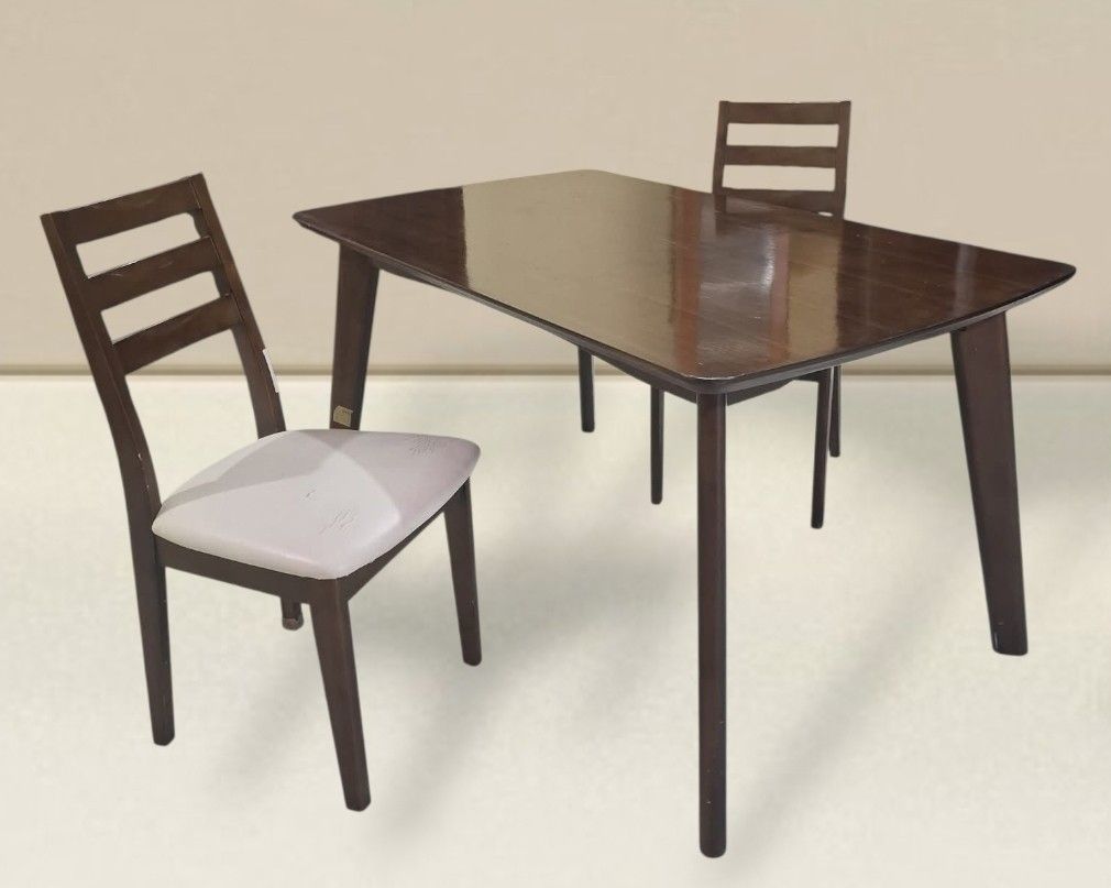 2 Seater Coffee Dining Table and Chairs Set (Category: Tables & Sets) located in Quezon City. Submitted by dannikkishoppe2 (Listing ID 1465384505, Image 1). Description: 2 Seater Coffee Dining Table and Chairs Set ‼️₱8000‼️ *good condition • Dark wood dining table and 2 matching chairs • Table dimensions: L53" W31.5" H28" • Chairs feature comfortable fabric cushioned seats • Solid wood construction with modern angled legs • Ideal space-saving set